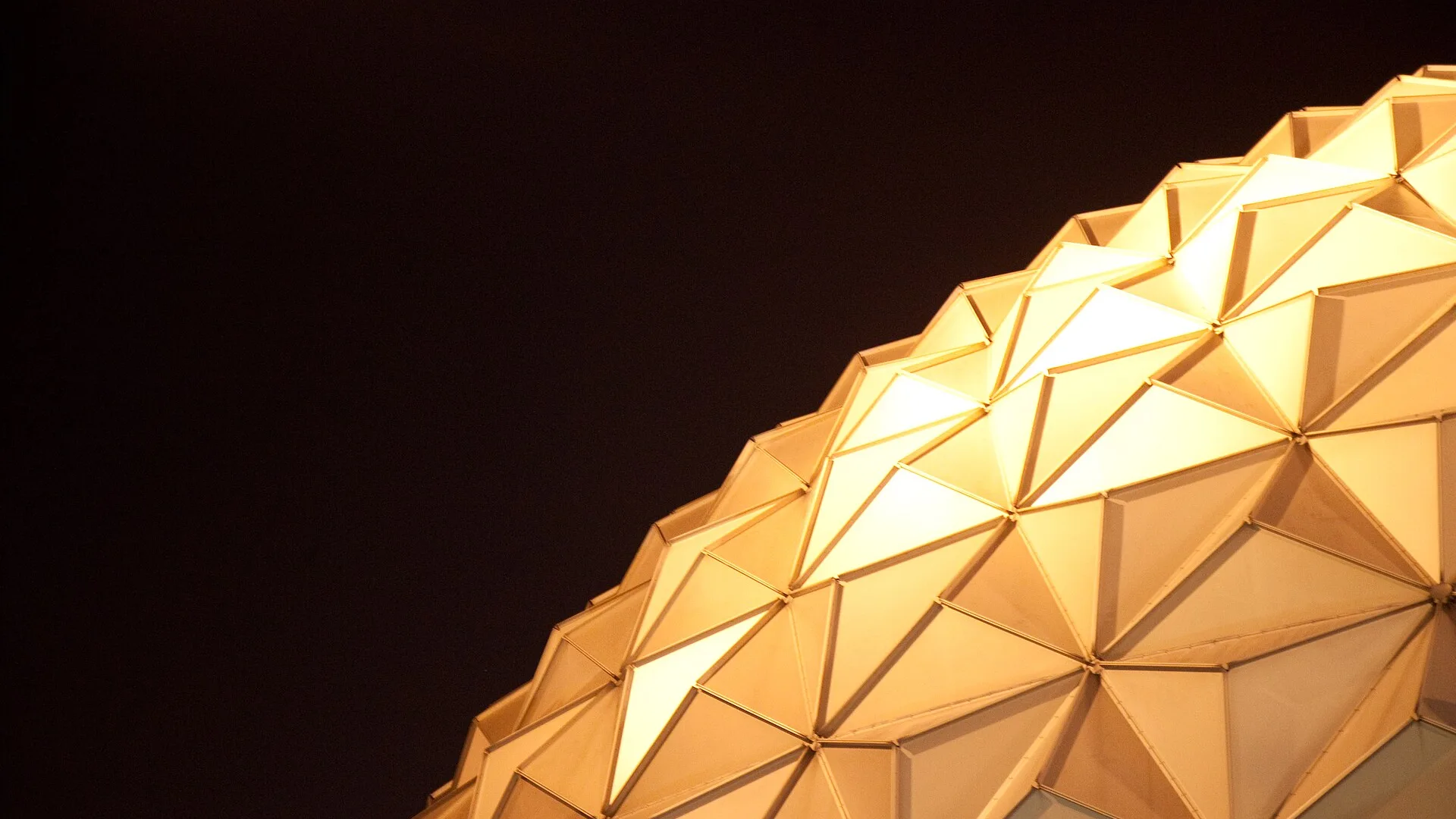 The illuminated geodesic dome of Shanghai Circus World at night
